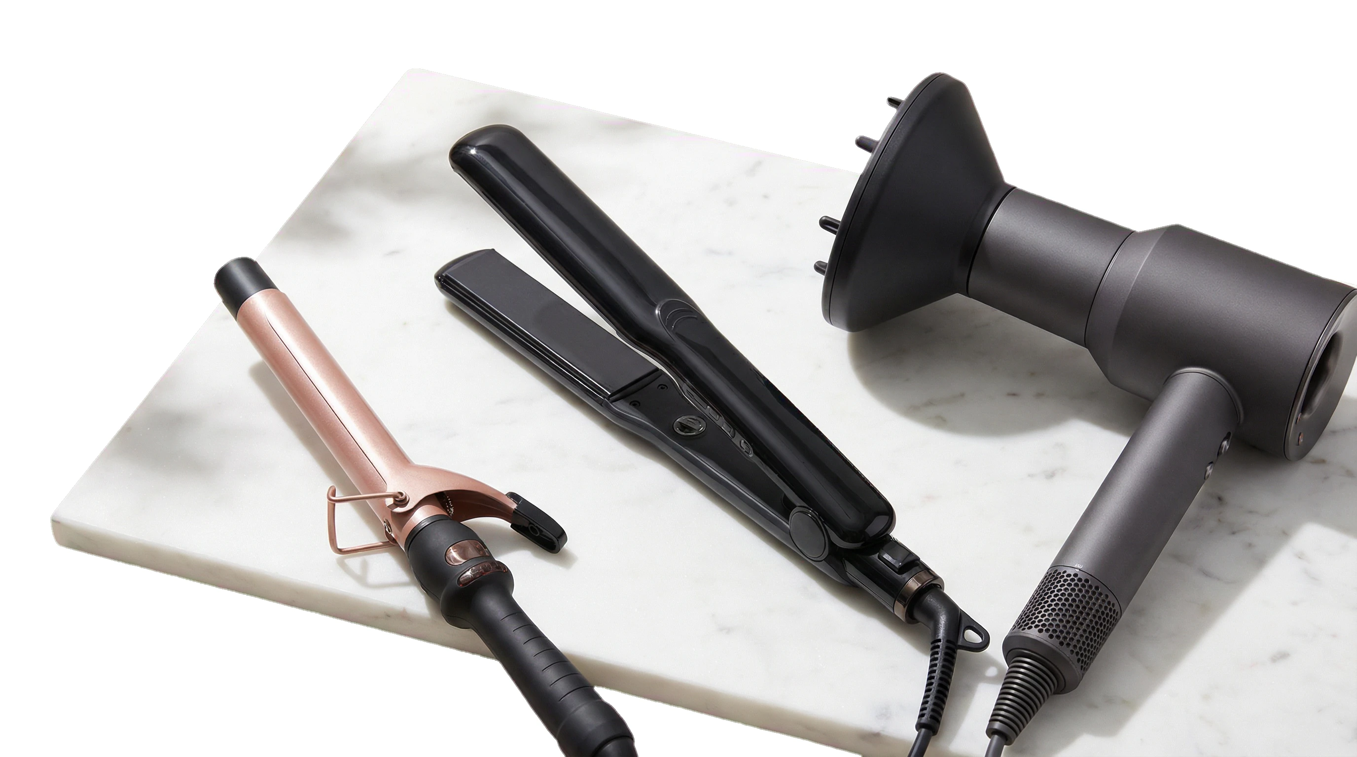 Premium Haarstyling-Geräte - Glätteisen, Lockenstab und Föhn auf Marmor